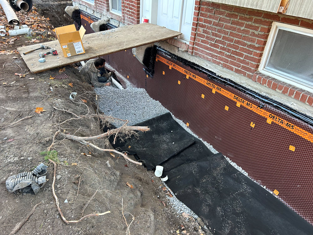 French drain installation showing excavation, pipe placement, and gravel backfill - key components that determine your final cost